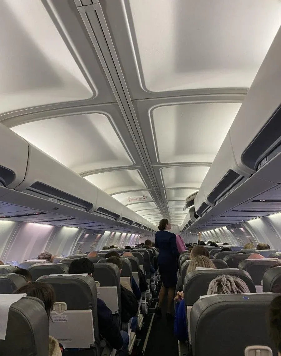 Проход CRJ-200 ЮТэйр: бортпроводник идёт к хвосту